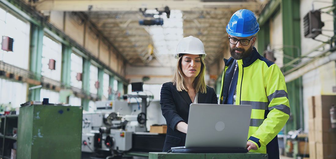 two people looking at a laptop