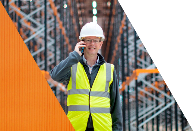 smiling warehouse operative on the phone